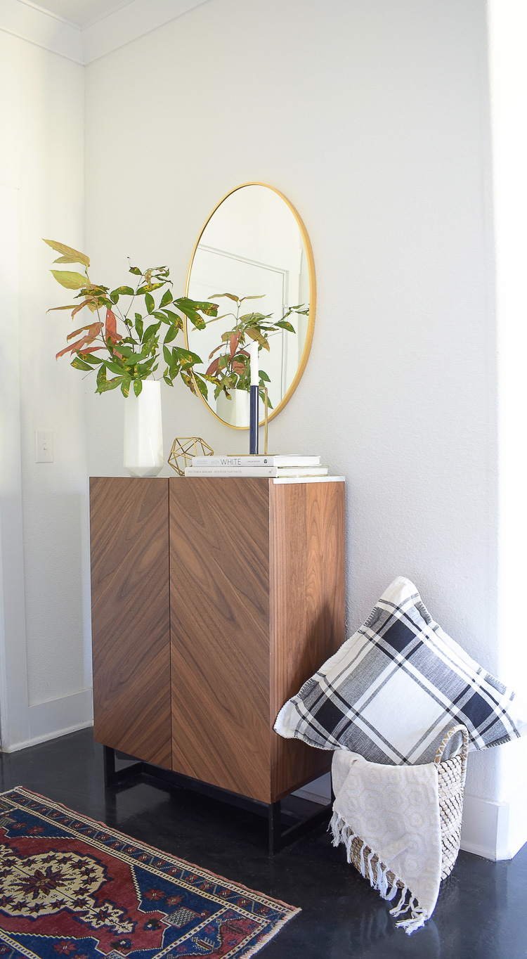 Chic modern fall styled entry - oval gold mirror, geometric gold home accessories 