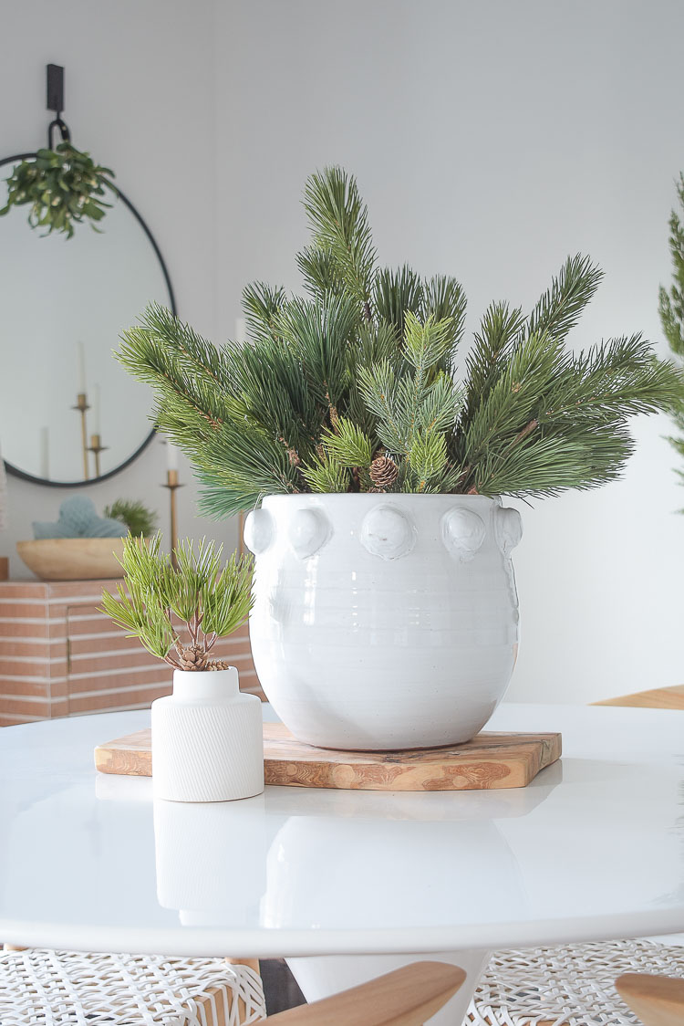 Christmas dining room tour - simple christmas centerpiece in white dotted pot 