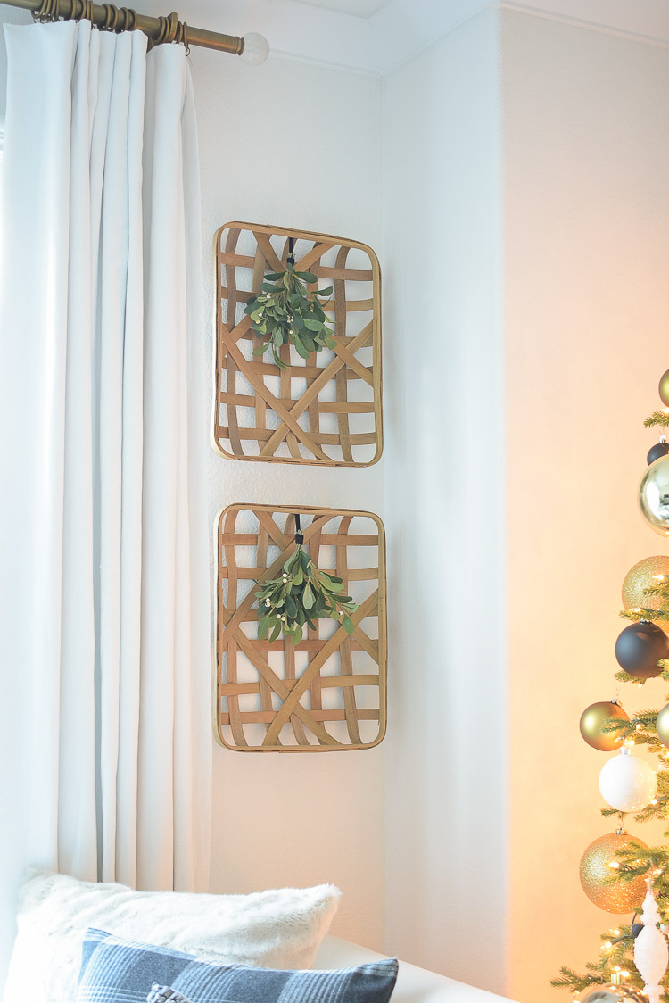 Black, white & gold Modern Christmas Living Room Tour - Modern farmhouse baskets with mistletoe attached