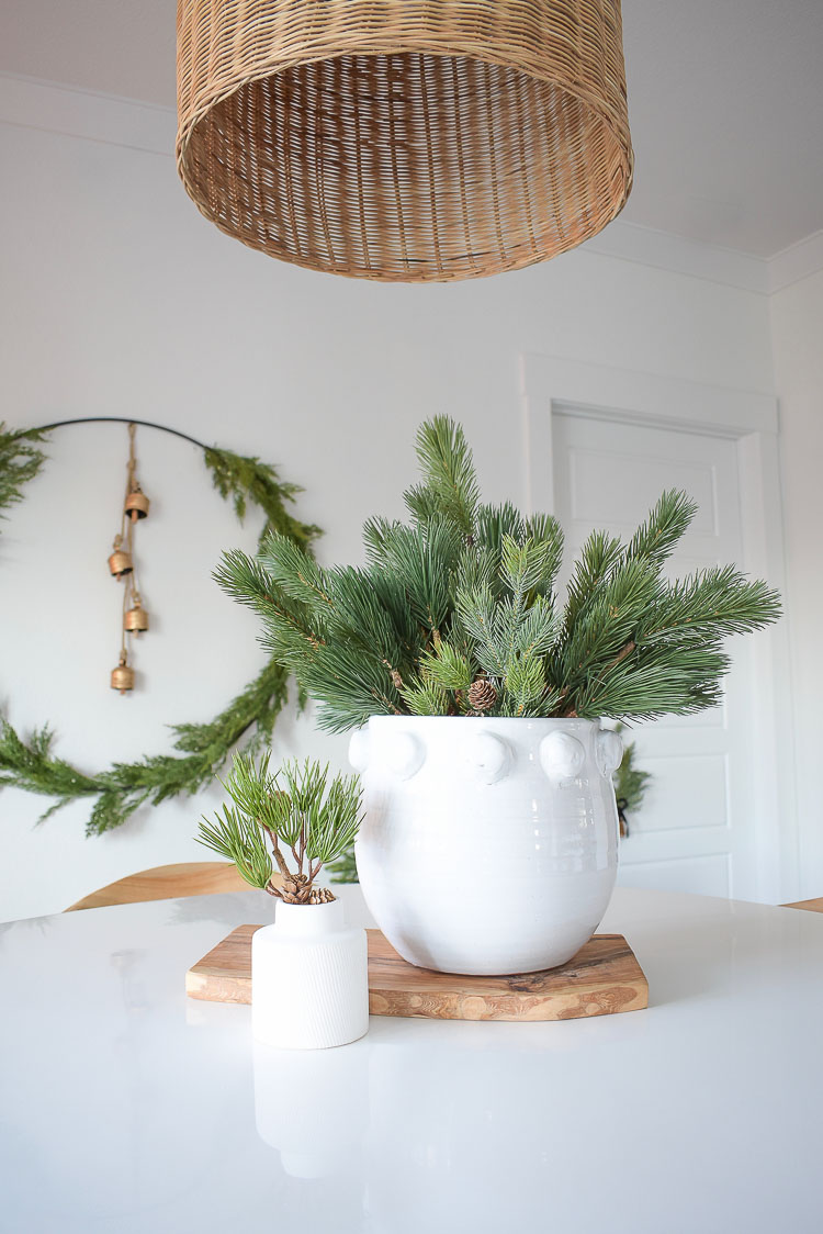 Christmas Dining Room Tour - White dot planter with pine branches centerpiece 