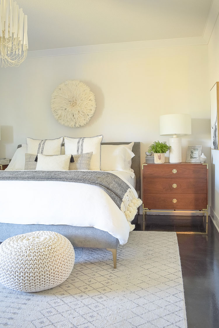 black and white spring bedroom tour - white bedding, juju hat, oversized tassel throw end of bed