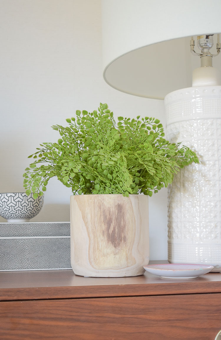 how to style your nightstand with faux greenery - faux fern in wooden pot 