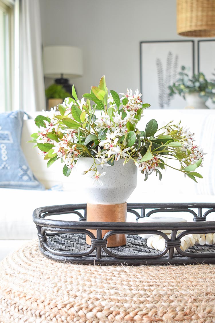 Spring flower arrangement with Indian Hawthorne on coffee table in spring tour 