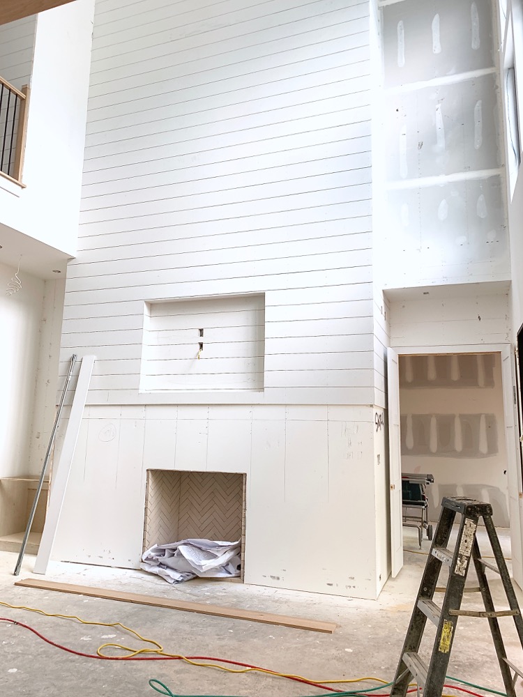 White Shiplap hallway - entryway in transitional modern home under construction 