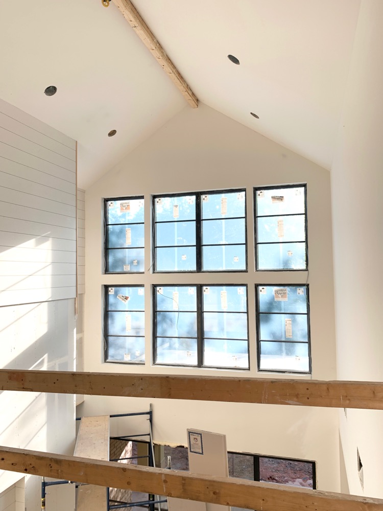 large modern windows in living room with vaulted ceiling 