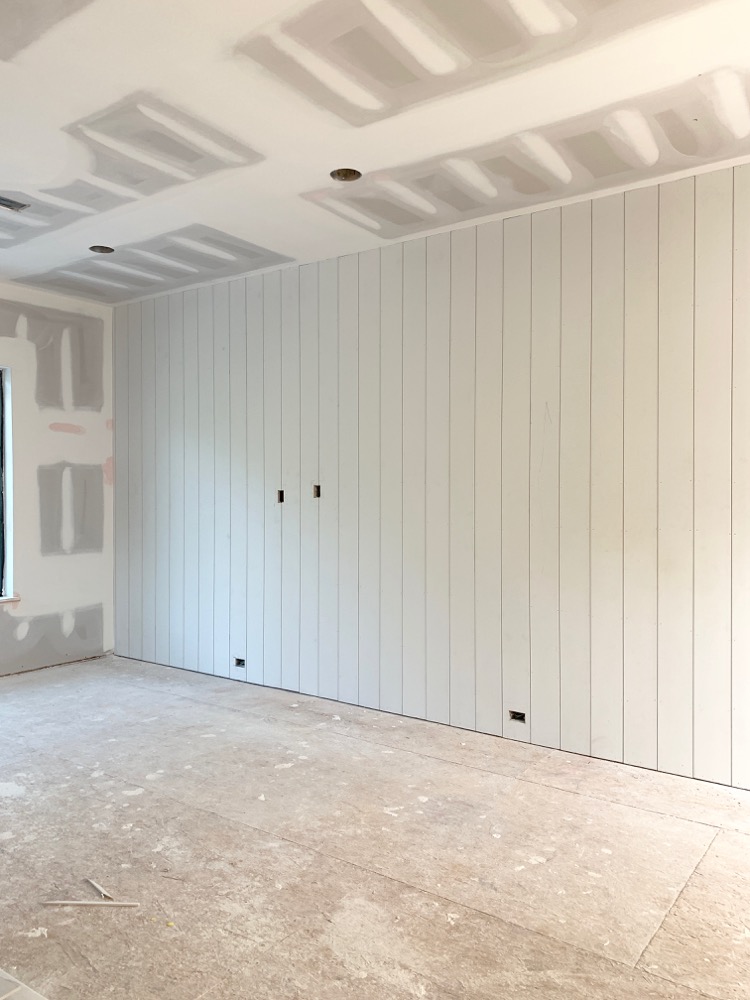 large game room under construction with vertical shiplap wall