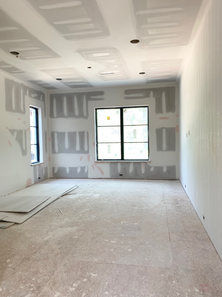 large game room under construction with vertical shiplap wall