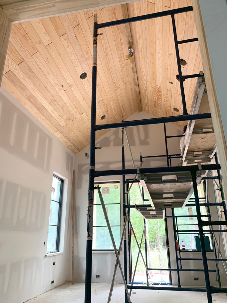 v-groove ceiling being installed in master suite 