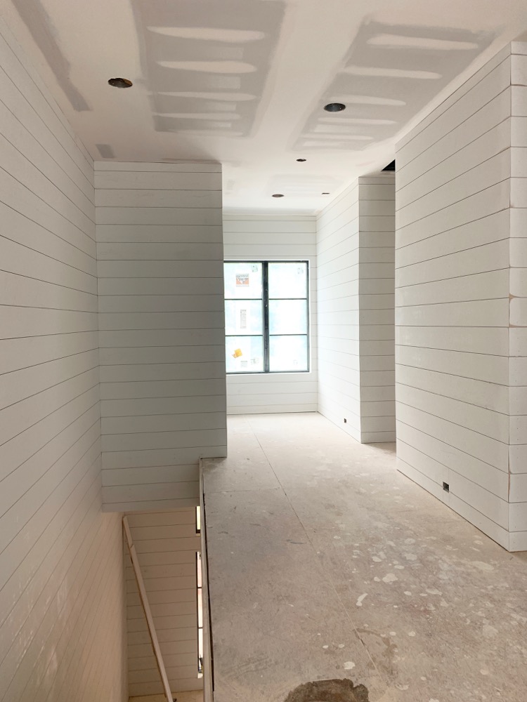 White shiplap in hallway on both sides 