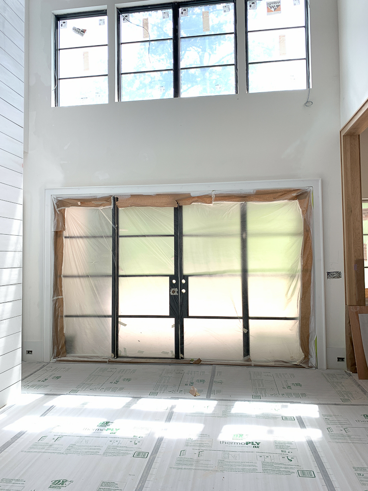 Modern farmhouse shiplap walls and fireplace, steel doors