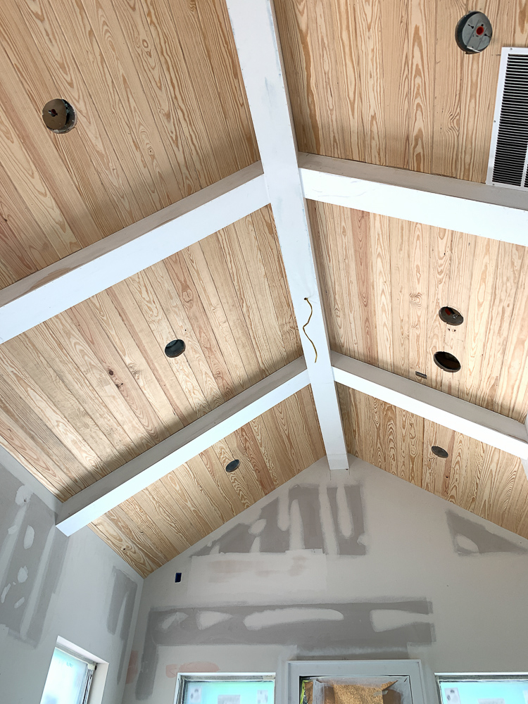 Master bedroom ceiling with tongue and v groove with box beams in white 