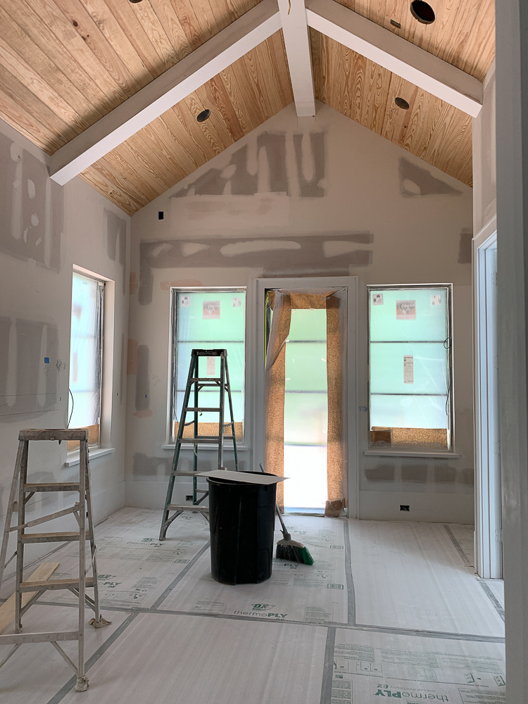 Master bedroom ceiling with tongue and v groove with box beams in white 