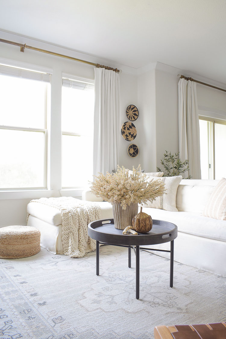 Fall living room tour - wall baskets, black round coffee table, neutral layers and fall pillows