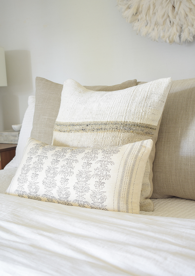 textured two-tone pillow with floral lumbar in front