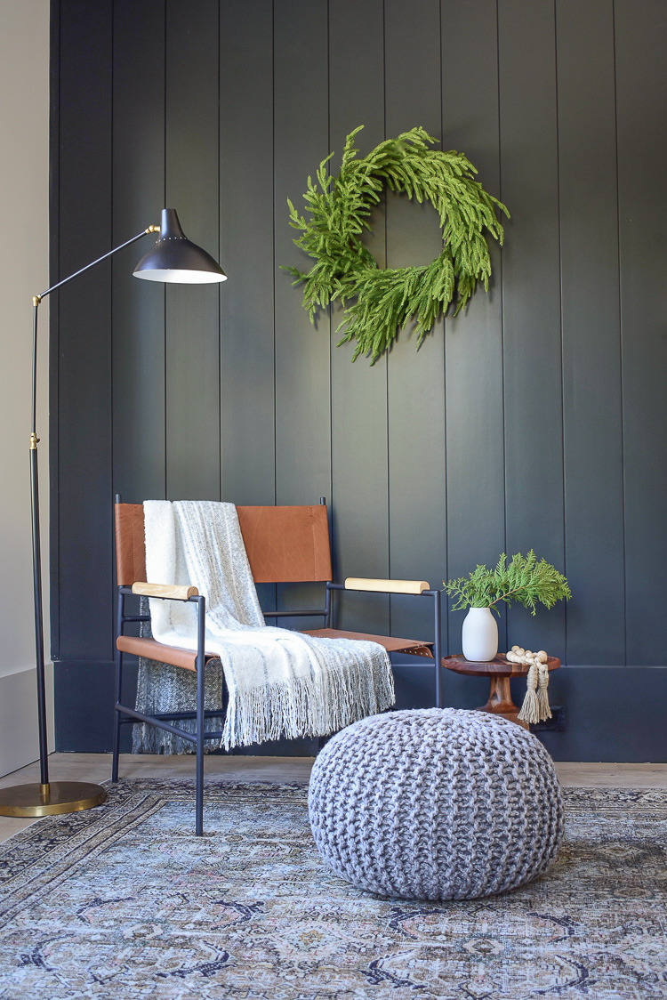 Modern leather sling chair with metal legs,black shiplap wall 