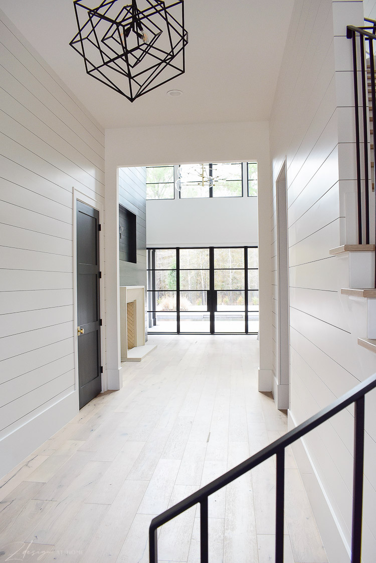 Large entry hall with shiplap and white oak floors