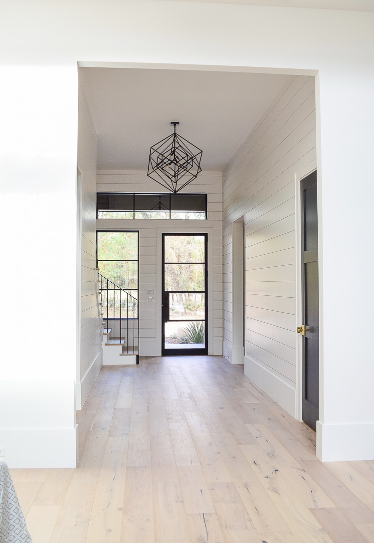 Large entry hall with shiplap and white oak floors