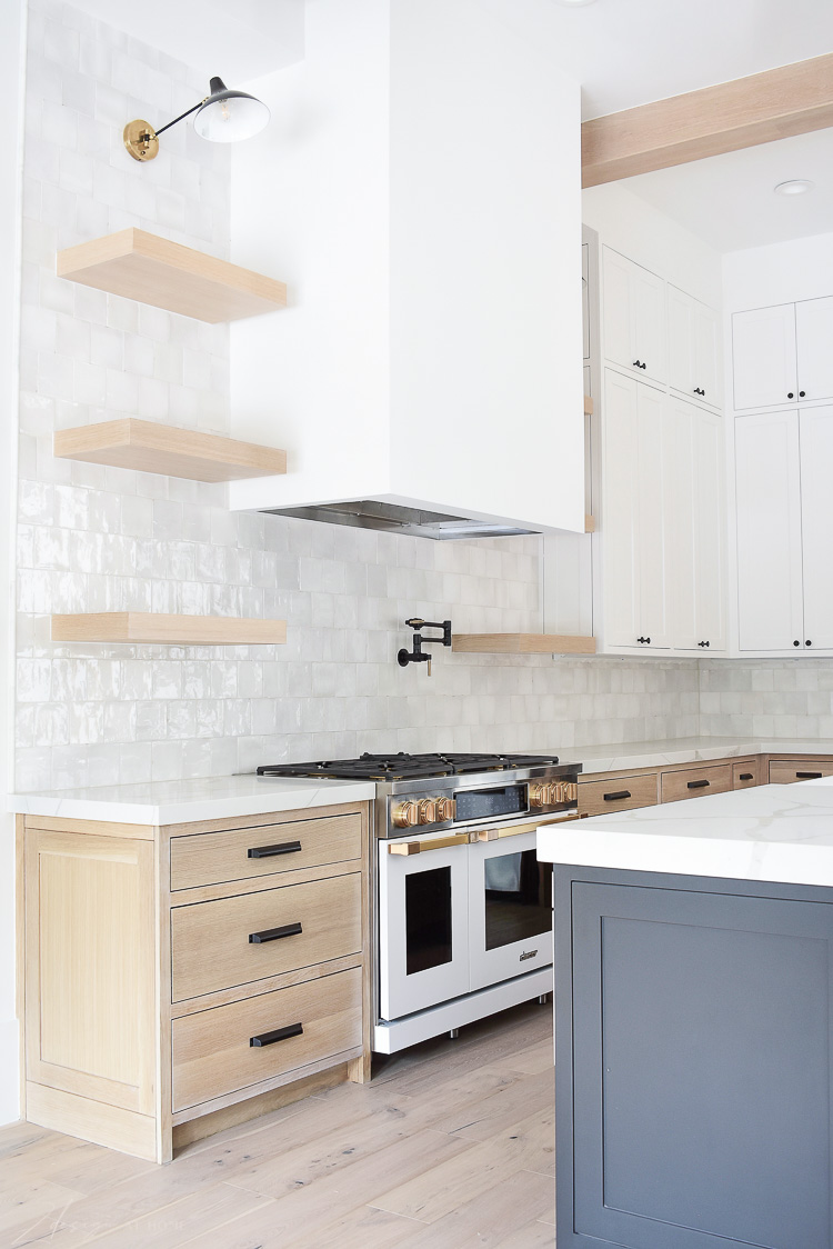 Kitchen design white oak cabinet, zellige tile, white range brass fittings 