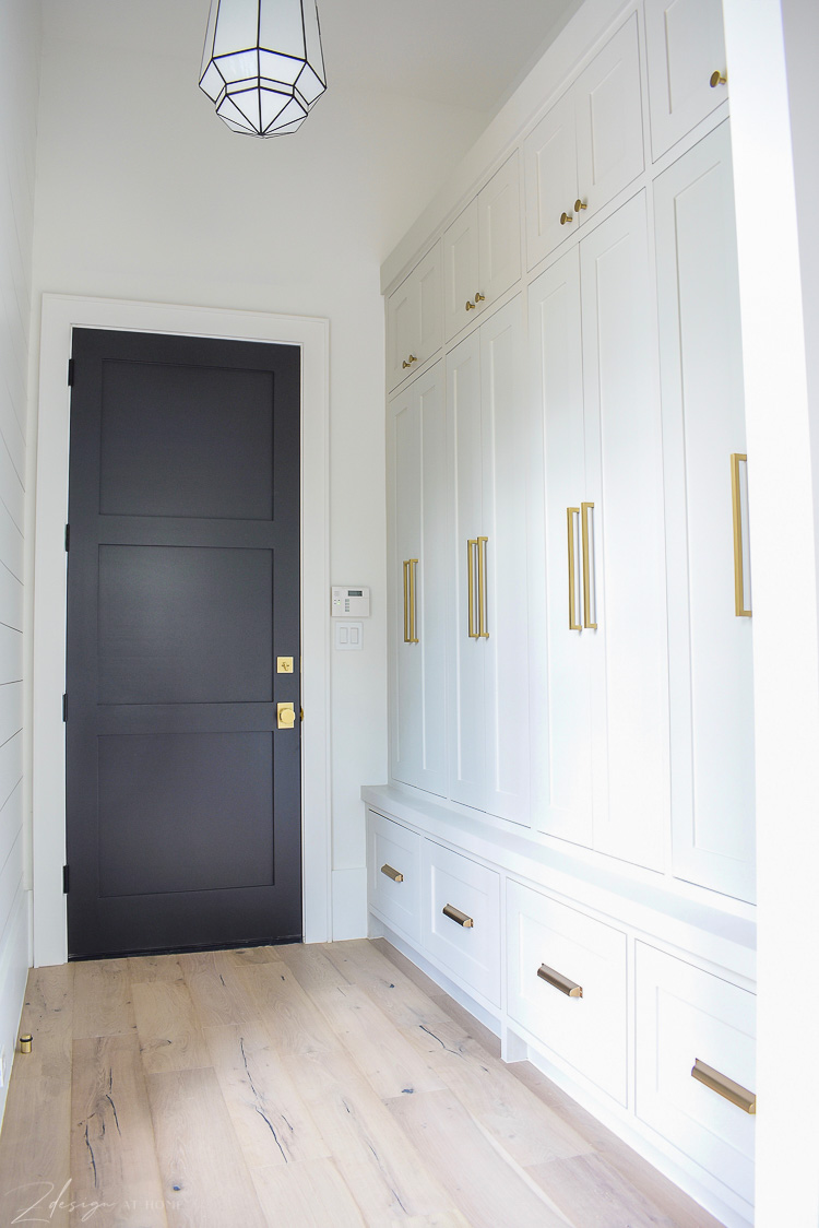 Mudroom with agreeable gray cabinets and modern brass hardware, white oak floors 