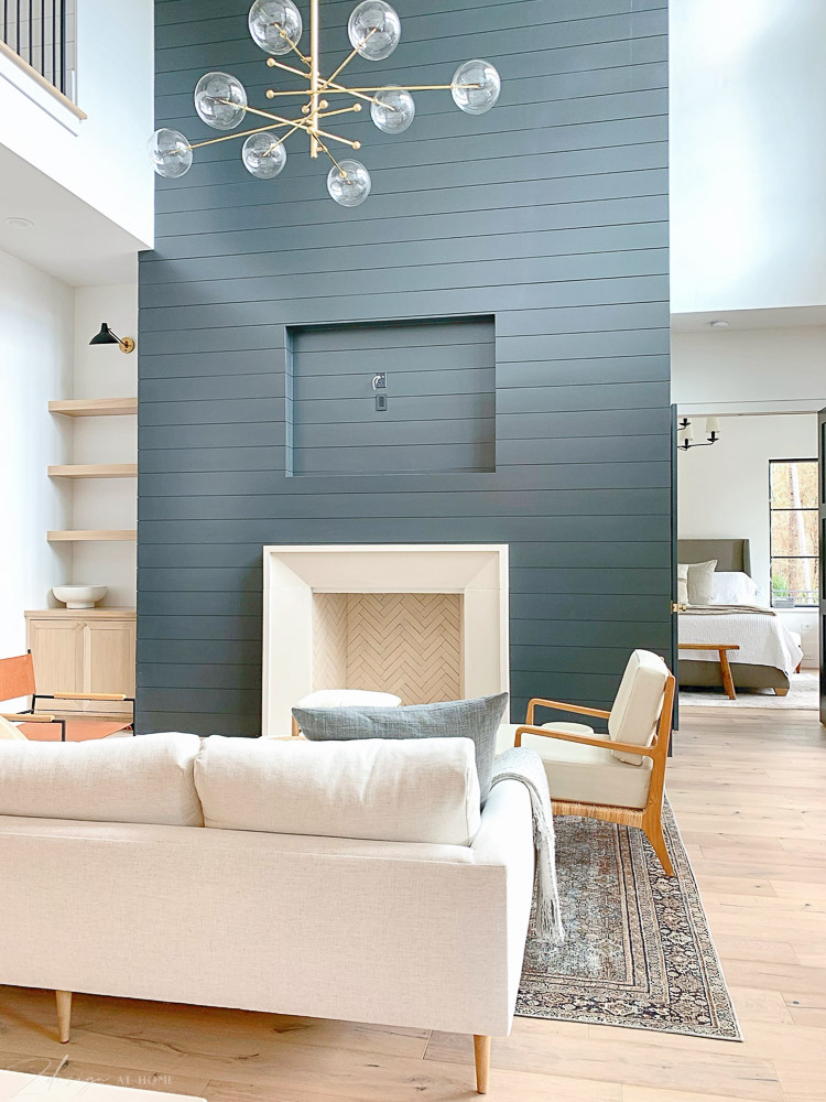 living room with black shiplap and capstone firempace, transitional modern style 