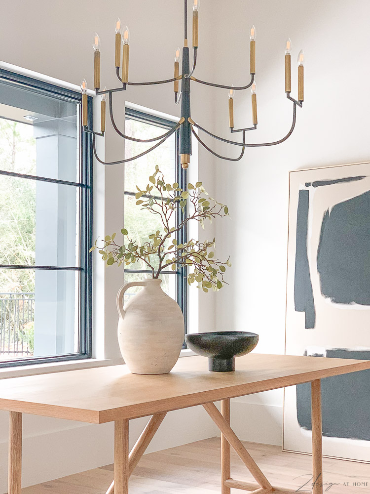 modern farmhouse dining room design - olive jar on dining table with modern black bowl