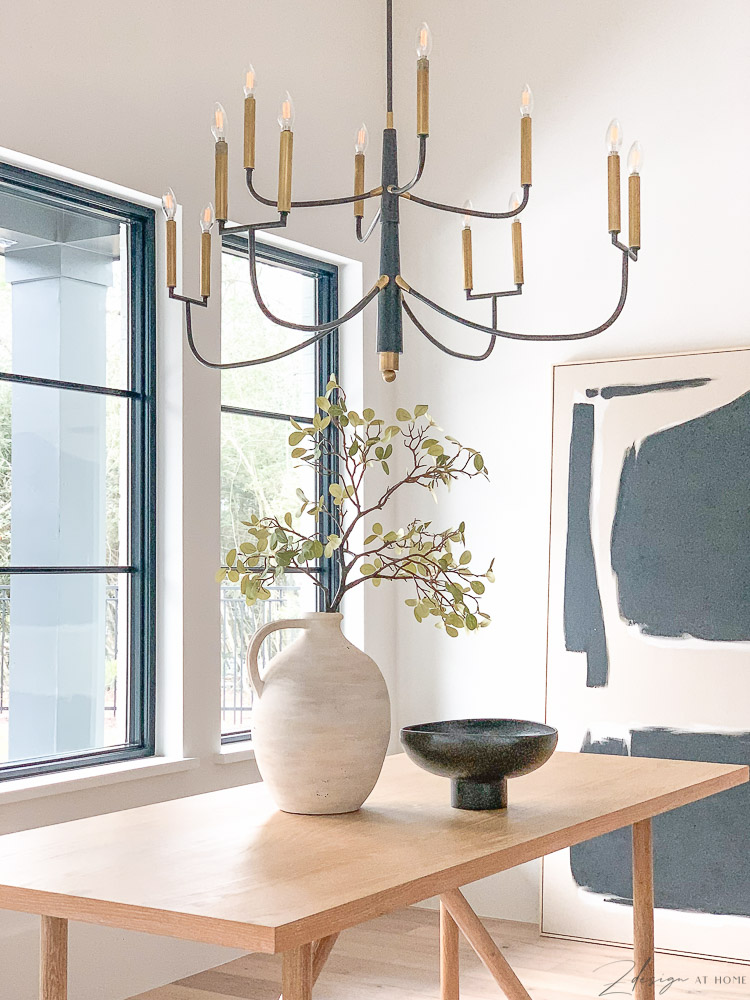 Beautiful transitional modern farmhouse dining room with abstract art and farlane chandelier