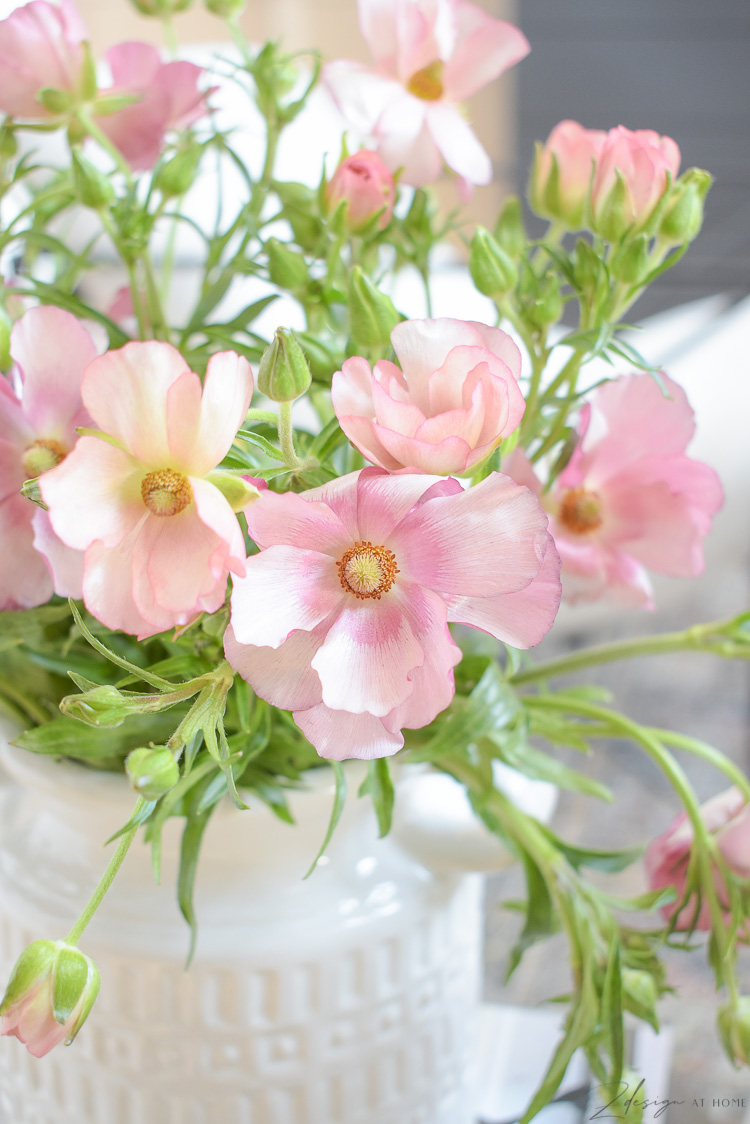 pink spring blooms in white jug vessel vase 