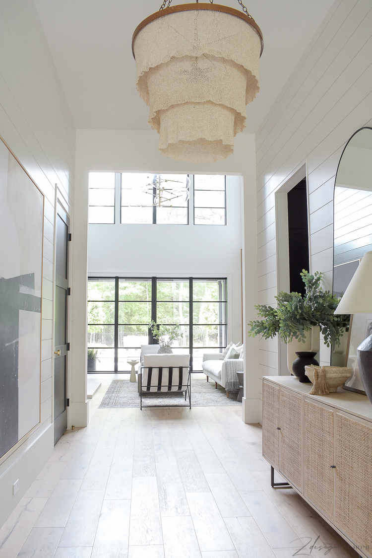 long entry hall with shiplap that goes into living room 