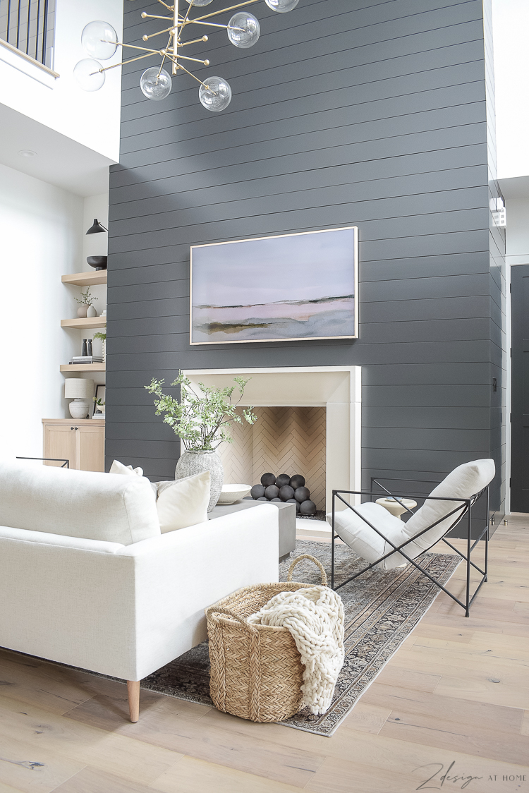 modern living room with black shiplap fireplace wall and isokern fireplace