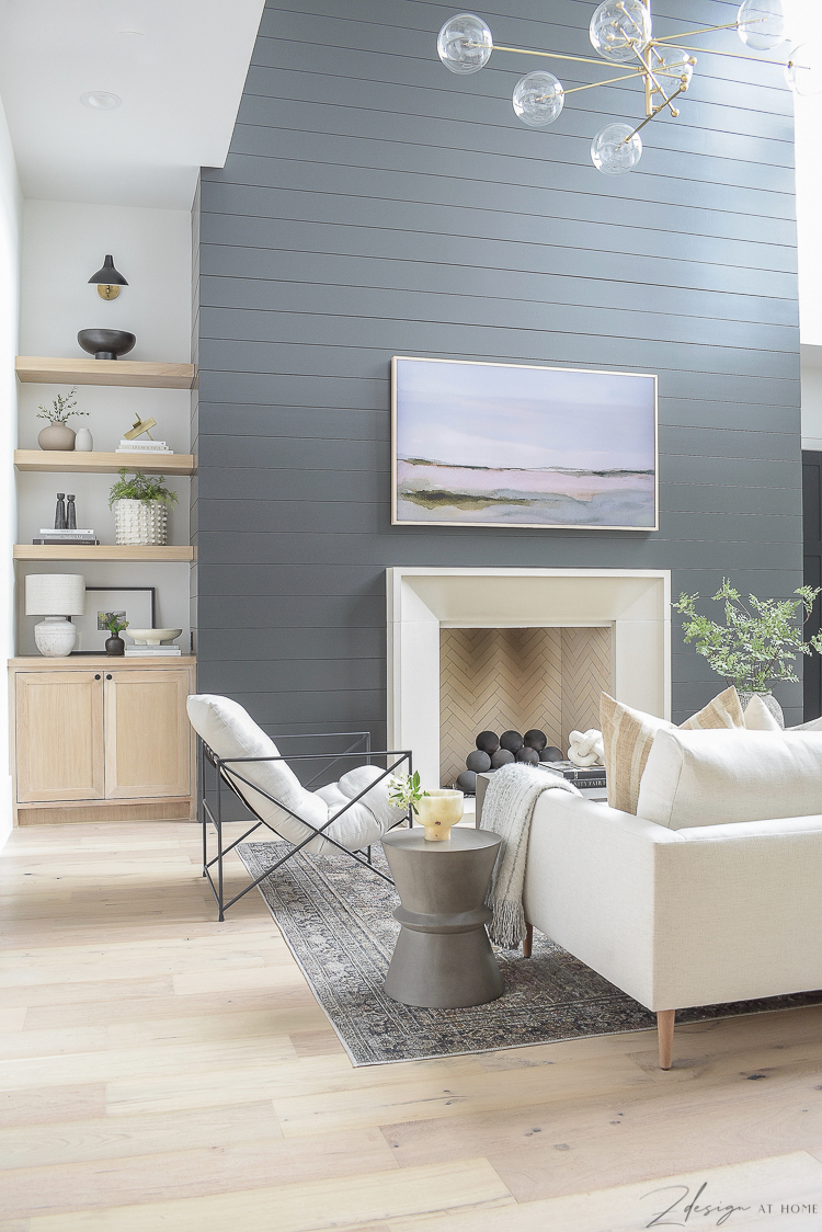 modern living room with black shiplap fireplace wall