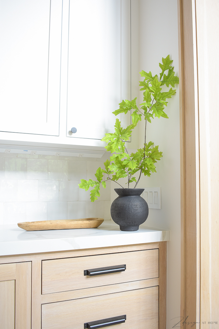 Oak stem in black CB2 pedestal vase 