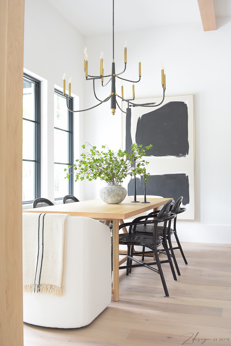 Transitional modern dining room with vase and stems, art and chandelier 