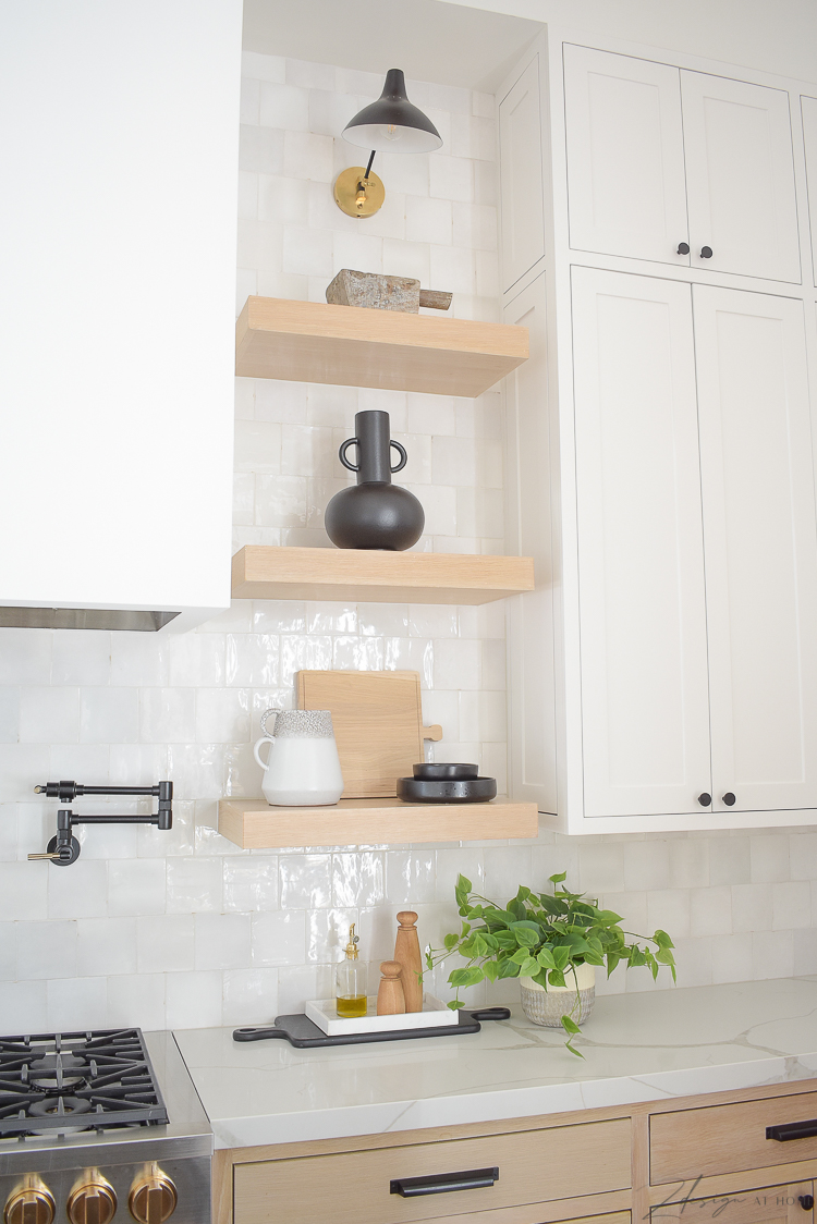 styled kitchen white oak shelves in front of zellige white tile 