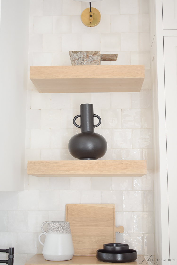 black olive jar styled on kitchen shelves 