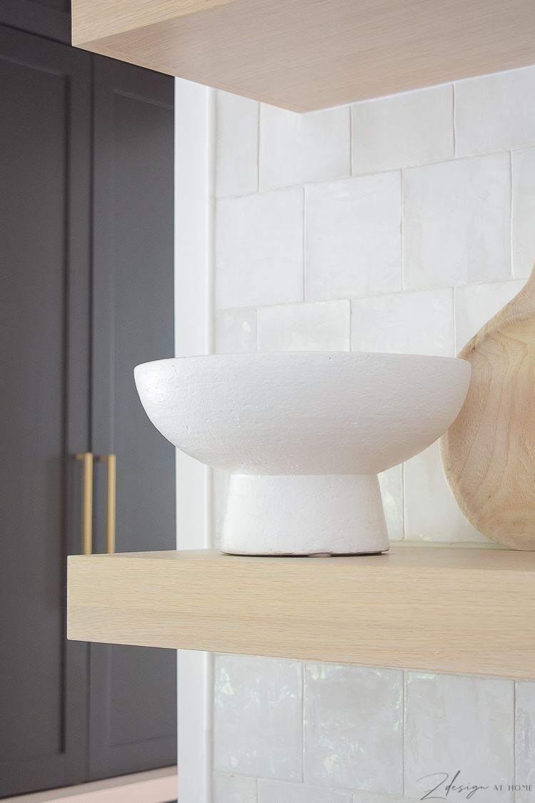 white pedestal bowl styled on kitchen shelves 