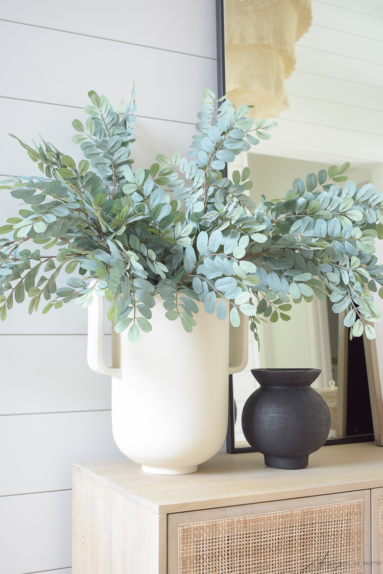 large white pedestal vase in foyer 