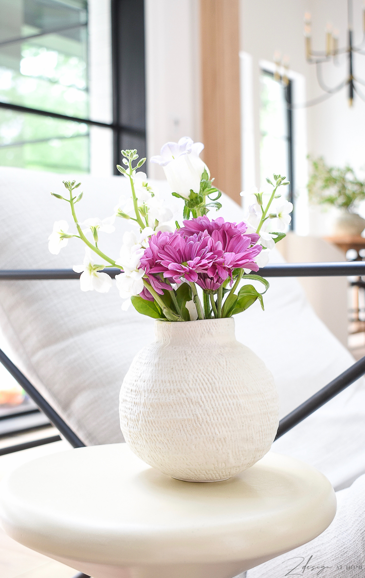 Small white bud vase with spring flowers 