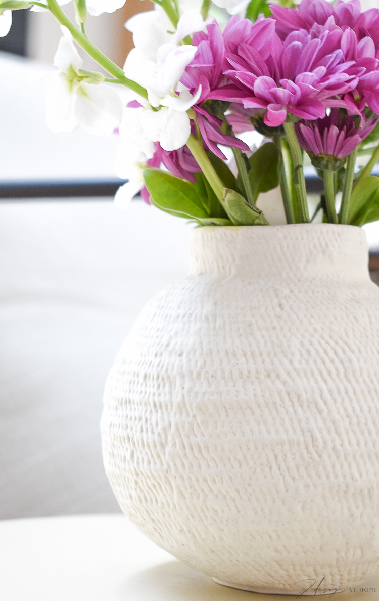 small white bud vase with fresh spring flowers 