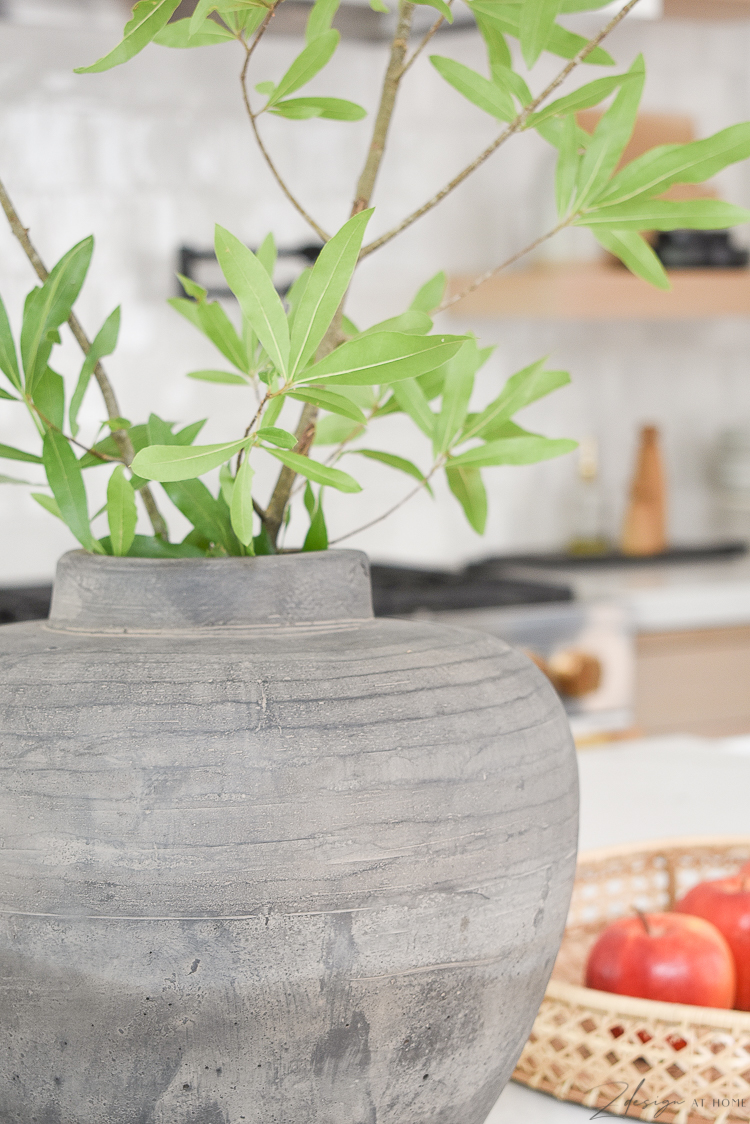 vintage inspired natural made vase on white quartz countertops 