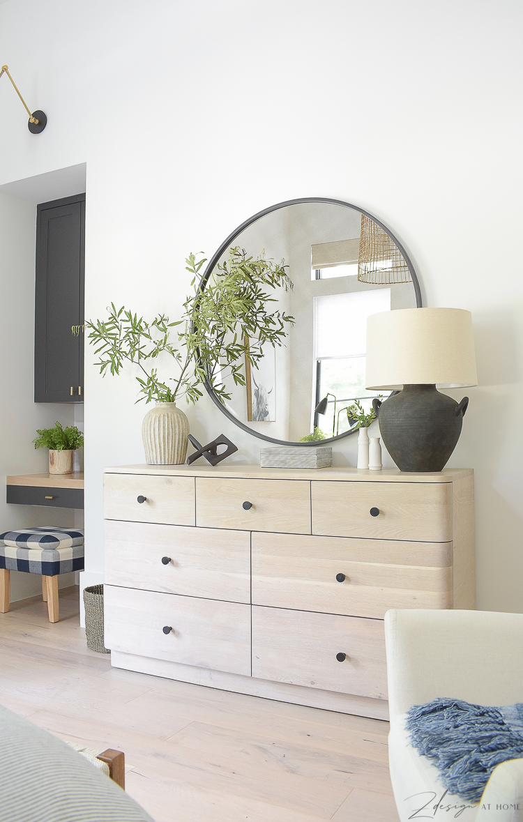 teenage boys room dresser, round black mirror styled with decor 