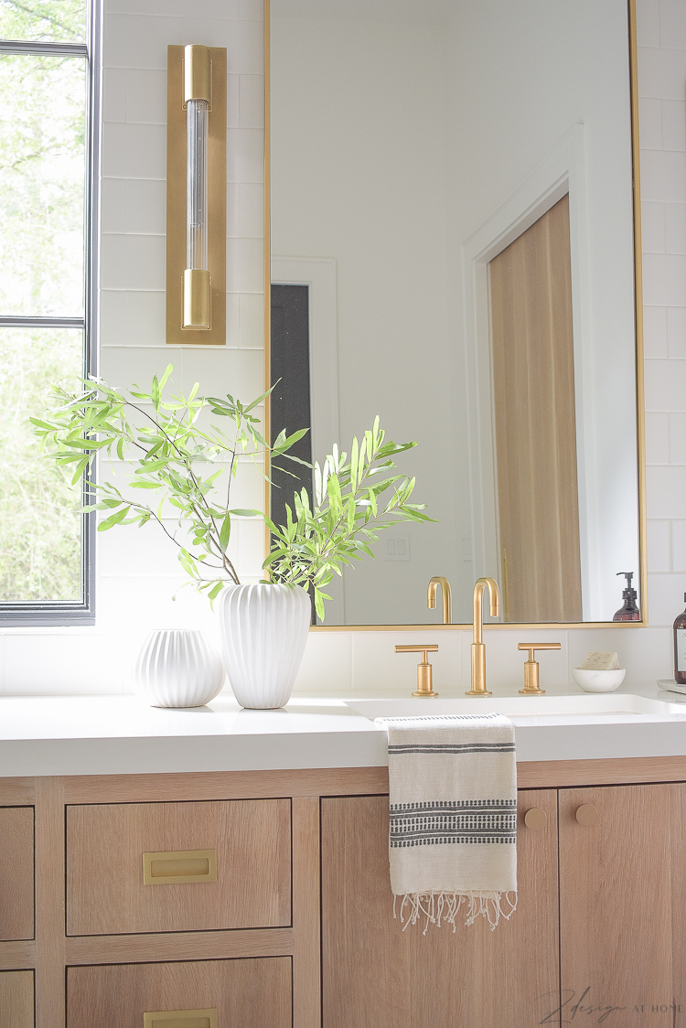 white ribbed vases on modern bathroom countertop 