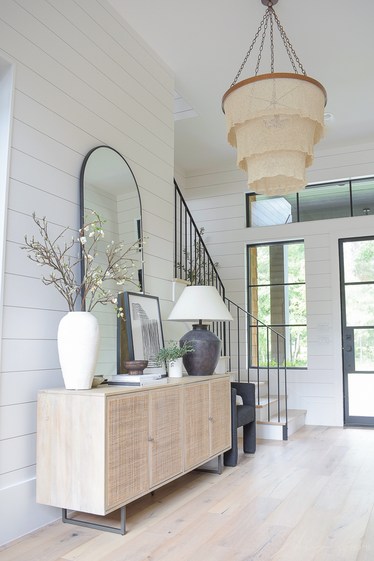 grand entryway styled with large roundd patricia chandelier 