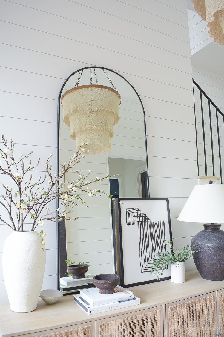 chandelier reflecting in mirror on console table - entryway 