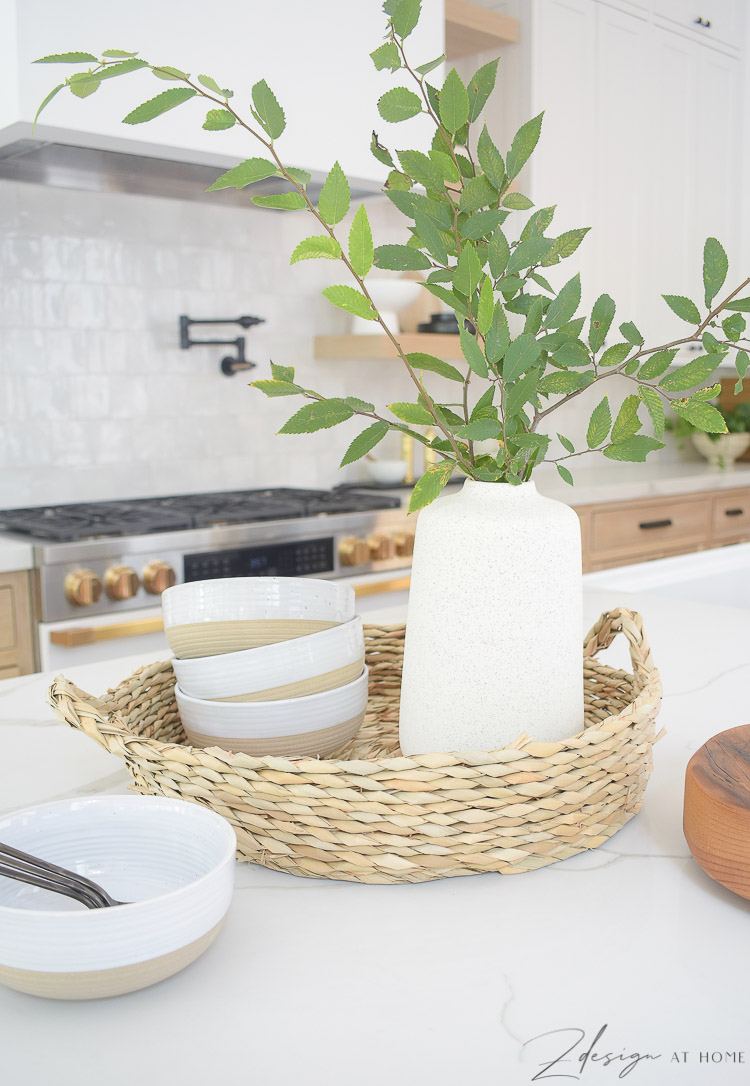 rattan tray with bowls and vase on kitchen island 