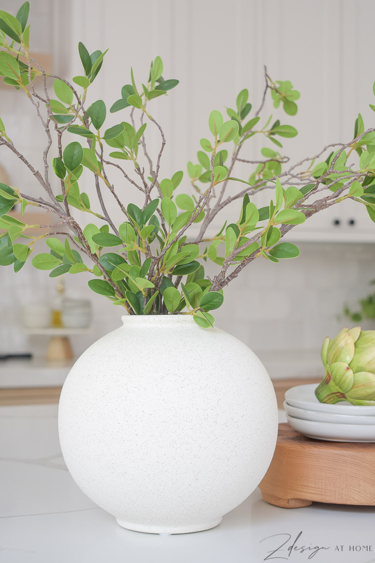 white speckled bubble vase styled on kitchen island