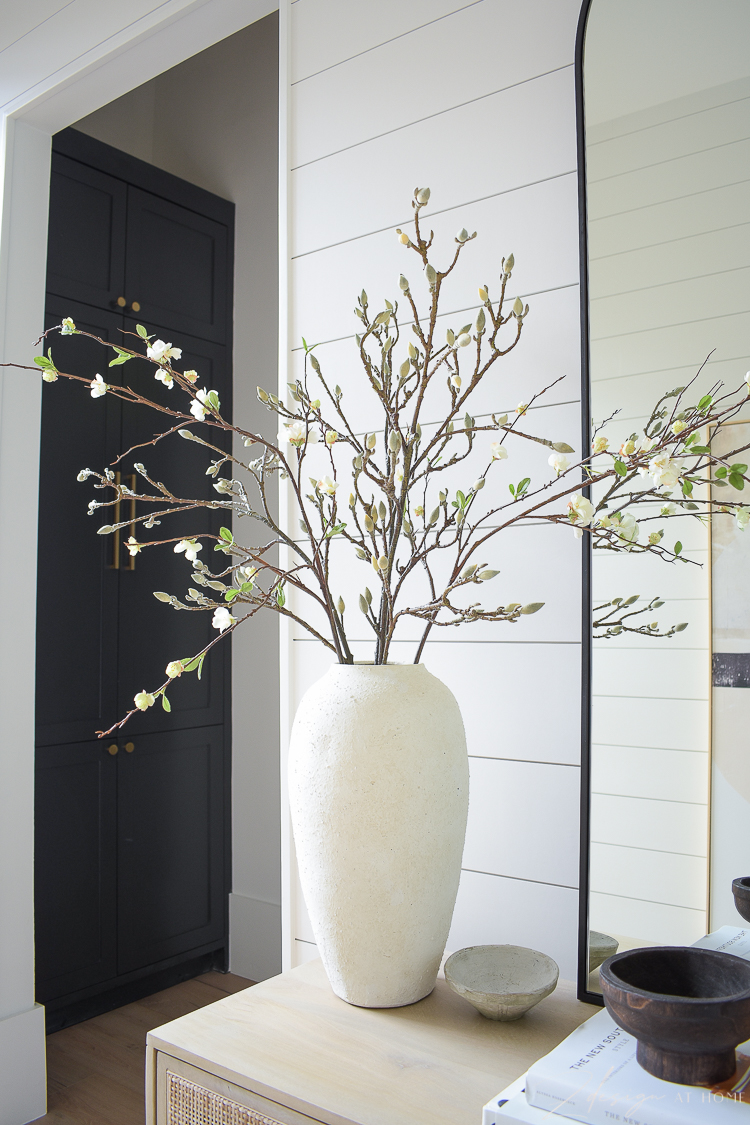 white cream textured vases with faux magnolia and quince stems branches 