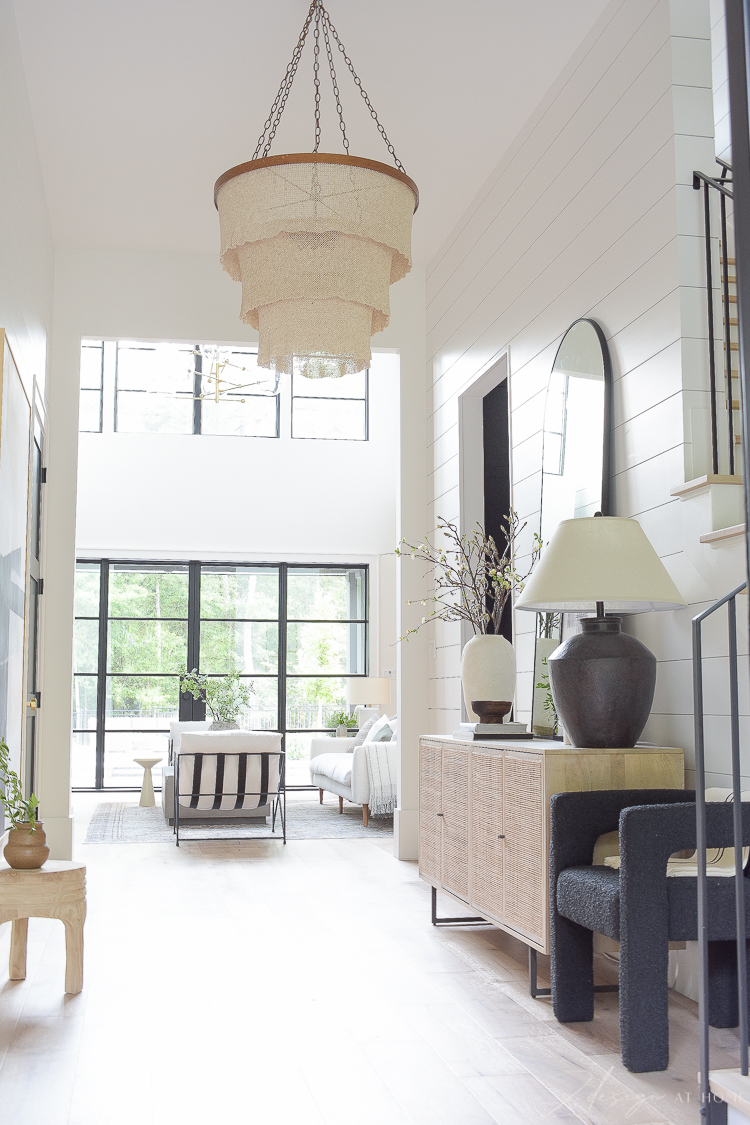 Grand foyer with white oak floors and shiplap walls