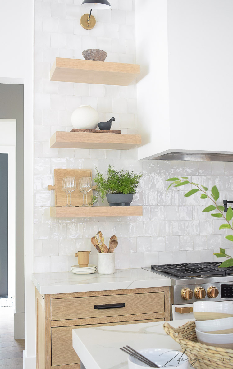 white oak open shelves in the kitchen with white zellige backsplash