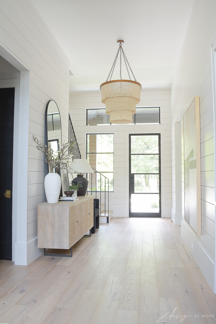 grand entryway hall with boho accents and patrica round chandelier 