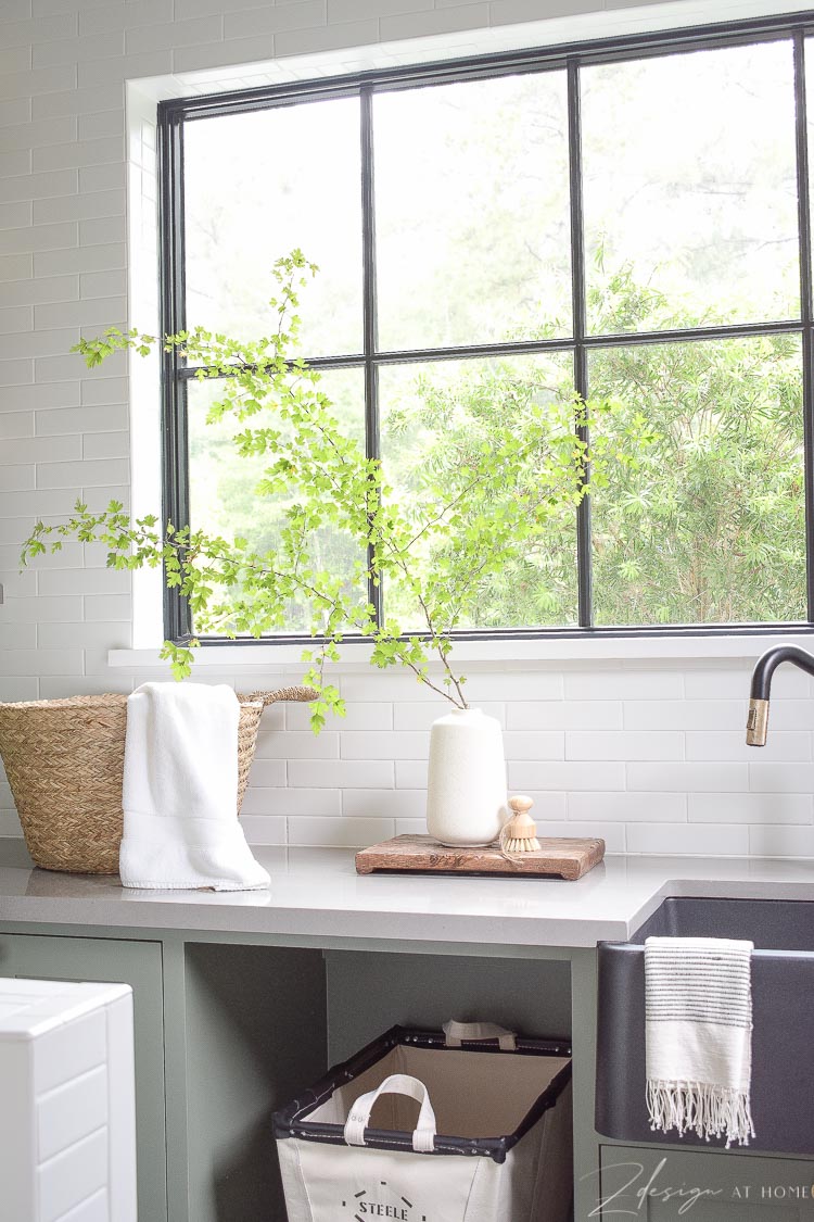 laundry room with gray countertops, tile to the ceiling 